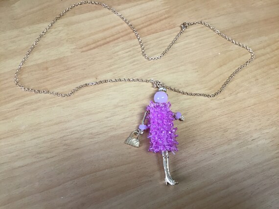 Doll necklace in pink tones and beaded dress