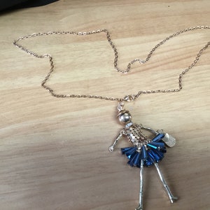 Doll necklace with beaded skirt