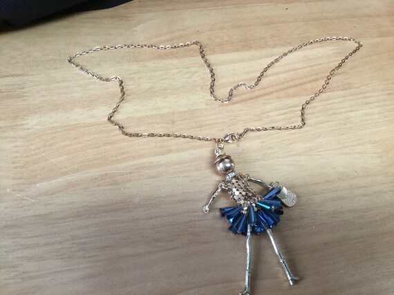 Doll necklace with beaded skirt