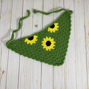 May include: Green crocheted triangle scarf with three yellow and brown sunflower appliques.