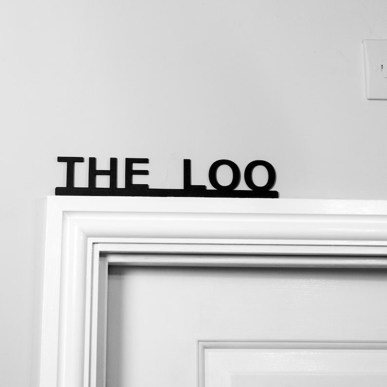 THE LOO word text sign used in the entryway for directions to the toilet and bathroom