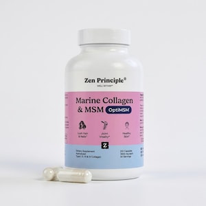 May include: A white bottle of Zen Principle Marine Collagen & MSM OptiMSM dietary supplement. The label is pink and blue, with text indicating benefits for hair, nails, joint vitality, and skin. Two capsules are in front of the bottle.