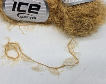 May include: A ball of light brown yarn with a label that reads "ice yarns". A strand of the yarn is pulled out, showing the texture. The yarn appears to be made of a natural fiber.