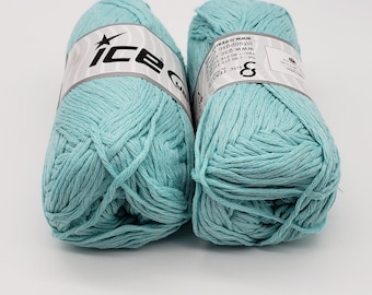 May include: Two skeins of light blue cotton yarn, each with a white label that reads "Ice Cotton" and includes information about the yarn's weight and length.