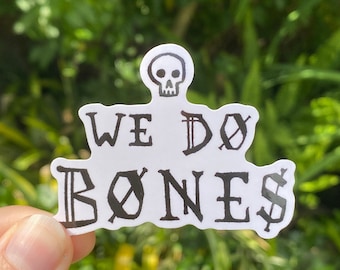 May include: White sticker with black text that reads "We Do Bones" with a skull graphic above the text.