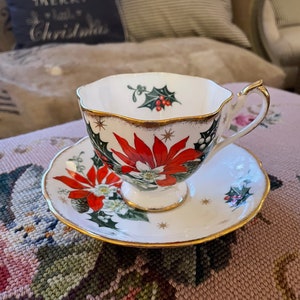 Vintage Queen Anne Noel Bone china teacup and saucer Gold rimmed Made in England Christmas Poinsettia print