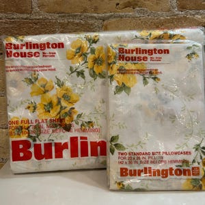 May include: Two packages of Burlington House percale bedding. One contains a full flat sheet, and the other contains two standard pillowcases. The sheets and pillowcases have a white background with a yellow floral pattern.