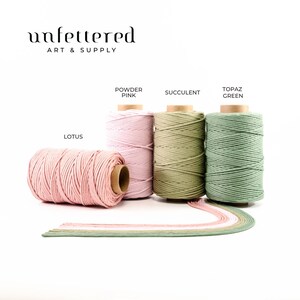 May include: Four spools of cotton cord in different colors: Lotus, Powder Pink, Succulent, and Topaz Green. The spools are arranged in a row on a white background. The text "Unfettered Art & Supply" is at the top of the image.