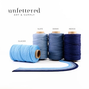 May include: Four spools of cotton cord in shades of blue, from light blue to dark blue. The spools are labeled "Glacier", "Slate", "Denim", and "Indigo".