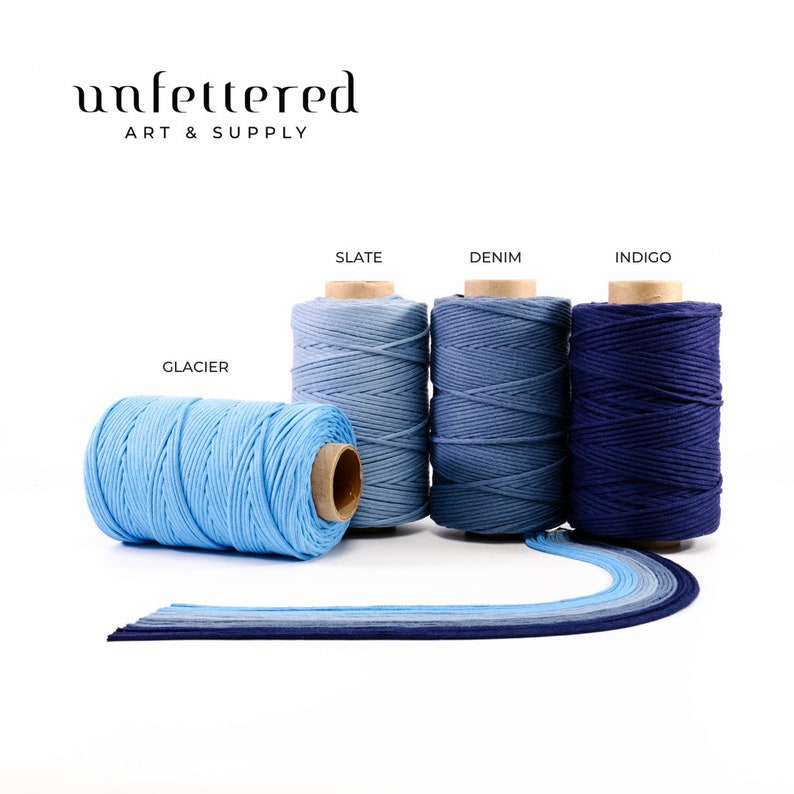 May include: Four spools of cotton cord in shades of blue, from light blue to dark blue. The spools are labeled "Glacier", "Slate", "Denim", and "Indigo".