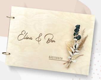 Elegant guest book made of wood for the wedding photo album with dried flowers photo book