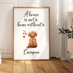 May include: A white framed print featuring a brown dog sitting with its back to the viewer. The print reads "A house is not a home without a Cavapoo" with red hearts floating above the dog.