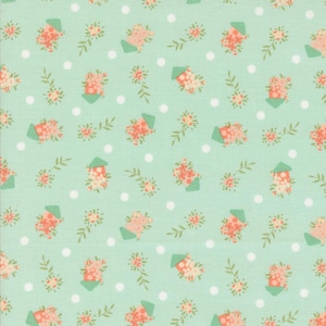 May include: A mint green fabric with a repeating pattern of white polka dots, pink flowers, and green leaves. The pattern also includes small, light green houses with pink flowers on the roof.