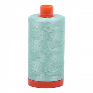 May include: A spool of light blue thread with an orange plastic bobbin.