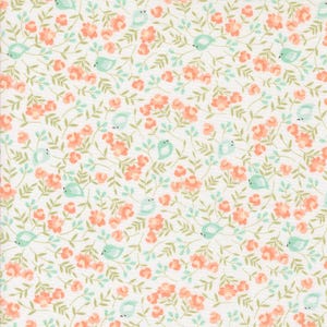May include: A fabric with a repeating pattern of peach-colored flowers, small green leaves, and light blue birds on a white background. The design is dense and creates a floral and avian theme.