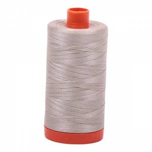 May include: A spool of light gray thread with an orange plastic top and bottom.