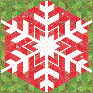 May include: A white snowflake design on a red and green patchwork background. The snowflake is made up of multiple triangles and squares, creating a geometric pattern. The background is a mix of red, green, and white fabrics with various patterns.