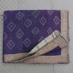 May include: A purple kantha quilt with a diamond pattern and a gold border. The quilt is folded in half and the inside is visible, showing a multi-colored pattern.