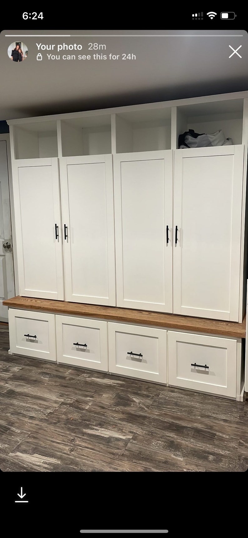 May include: White wooden cabinet with three doors and three drawers. The cabinet has black handles and a wood top.