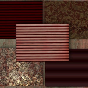 May include: A collage of patterned paper samples in shades of red, brown, and gold. Designs include stripes, floral, and damask patterns. The papers are arranged on a weathered wooden surface, creating a vintage aesthetic.
