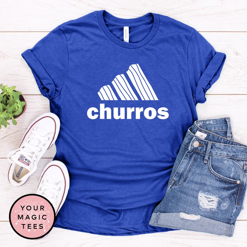 May include: A royal blue t-shirt with a white graphic of a stylized mountain range with the word "churro" printed below it.