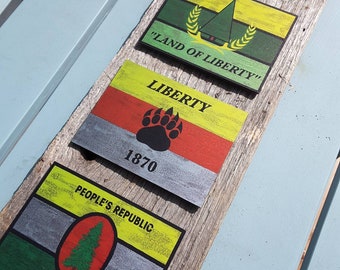 Brushed Aluminum Jedburgh wings and Pineland Flag prints on barnwood.