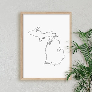 May include: A black and white line drawing of the state of Michigan with the word "Michigan" written underneath in cursive.