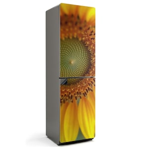 May include: A refrigerator with a vibrant sunflower design. The image features a close-up of the sunflower's yellow petals and the green spiral center. The refrigerator has a gray body and a two-door design.