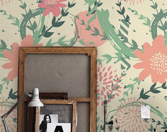 May include: A room interior with a wall covered in a floral wallpaper featuring a pink and green pattern. The wallpaper has a vintage feel and features a variety of floral shapes. The room is decorated with a wooden frame, a lamp, and other decorative items.