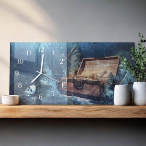 May include: A rectangular wall clock featuring a pirate theme. The clock face displays a treasure chest filled with gold coins and jewelry. The background has a blue and gray underwater scene with a skull. The clock hands are white.