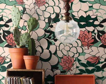 May include: A vintage record player with a wooden case and a turntable. The record player is sitting on a wooden table in front of a wall with a floral wallpaper. There are two potted cactus plants on the table.