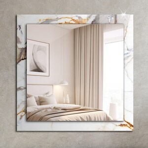 Può includere: Specchio quadrato con cornice a motivo marmoreo. La cornice presenta toni bianchi, oro e grigio. Lo specchio riflette una scena di camera da letto con un letto, opere d'arte e una finestra con tende. Design moderno ed elegante.