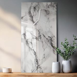 May include: A rectangular wall clock featuring a white and gray marble pattern across its surface. The clock face displays thin white hour and minute hands and includes white numerical hour markers from one to twelve arranged in a circular pattern.