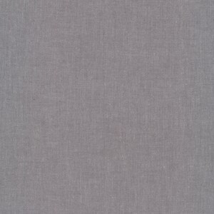 May include: A close-up of a plain, light gray fabric with a subtle woven texture.
