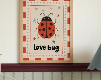 May include: A framed print featuring a cartoon ladybug with a red body and black spots. The print has the words "love bug" in black text. The frame is light brown, and the background is off-white with a red and pink border.