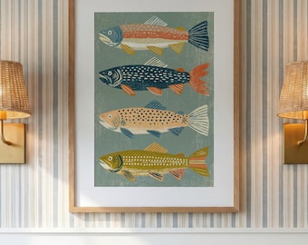 May include: A framed art print featuring four stylized fish stacked vertically against a muted green background. The fish are rendered in distinct colors including orange, dark blue, tan, and olive green, each with unique patterns and textures.