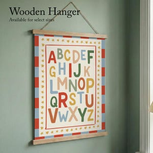 May include: A colorful alphabet poster with a wooden hanger. The poster features the letters A through Z in various colors, framed by a red border with blue and red stripes. The text "Wooden Hanger" is at the top.