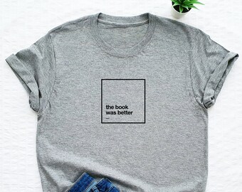 Pode incluir: Uma camiseta cinza com o texto "the book was better" impresso em um quadrado preto na frente.