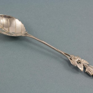 Sugar spoon made of silver with beautiful rose, silverware