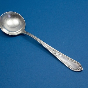 Silver-plated cream spoon with rococo decorations
