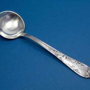 Silver-plated cream spoon with rococo decorations