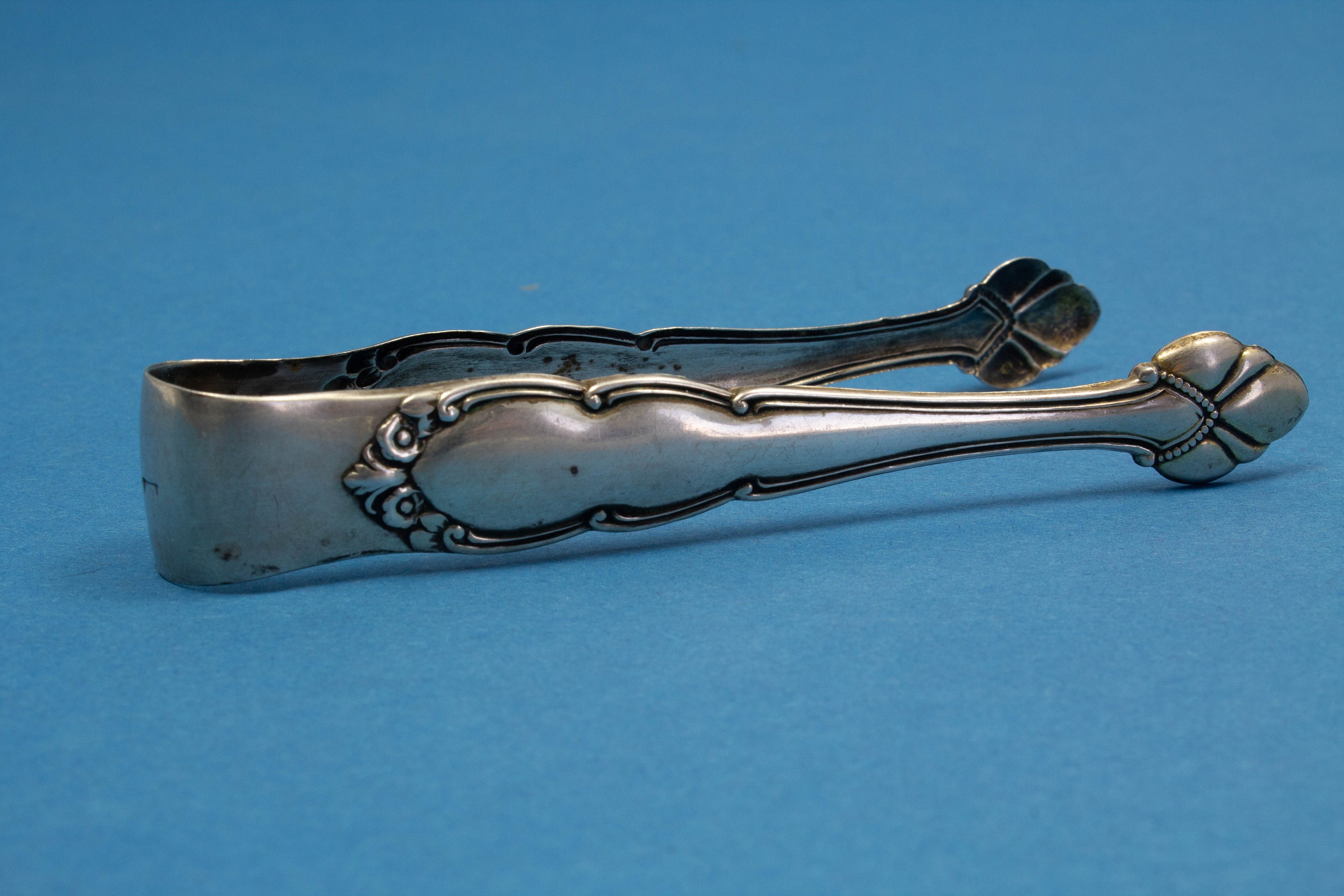 Noble sugar tongs of 800 silver