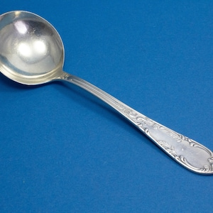 Silver-plated cream spoon with rococo decorations