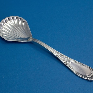 Silver-plated sugar spoon with rococo decorations