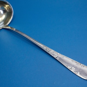 Large silver-plated rococo soup ladle