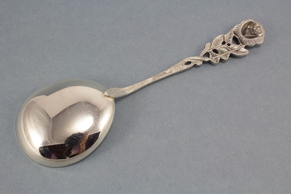 Ornate Silver Teaspoons, Four Spoons with Floral Handles, Arranged in a  Fan-like Manner and Connected