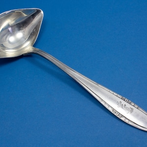 Silver plated sauce trowel , engraved