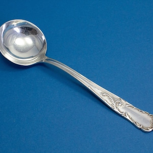 Silver-plated cream spoon with rococo decorations