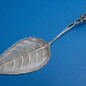 Silver pastry server, rose pattern