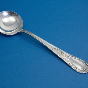 Silver-plated cream spoon with rococo decorations